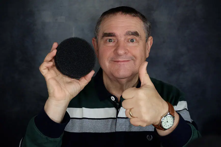 Man holding a fish tank filter foam pop filter